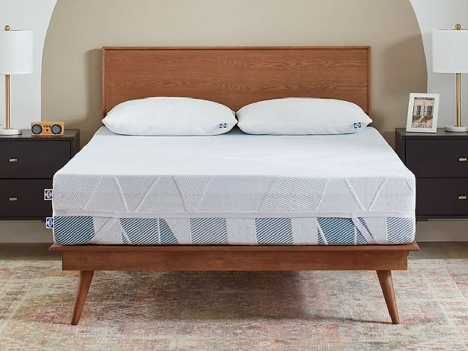 blue mattress topper on bed with two pillows