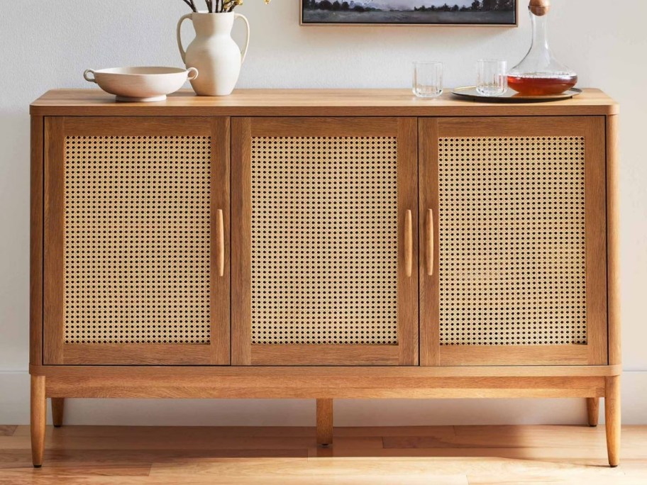 a light colored wooden with caning sideboard