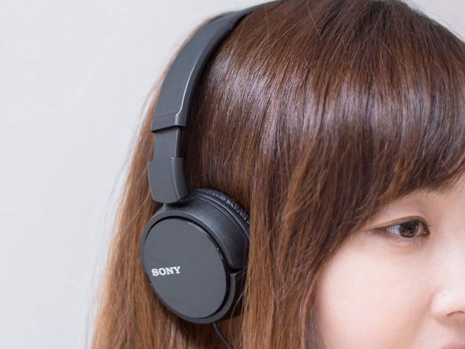 woman wearing black sony headphones