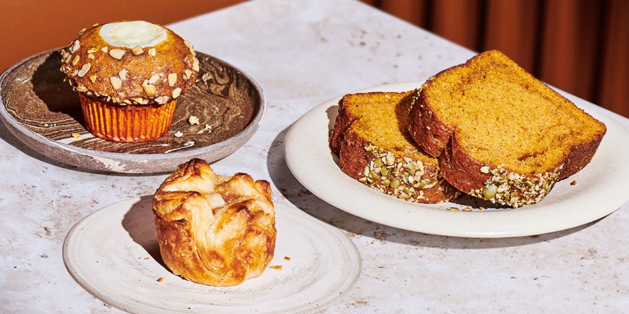 muffin, croissant, and loaf plated on table