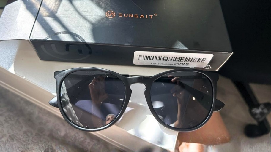 a pair of black framed sunglasses on a countertop