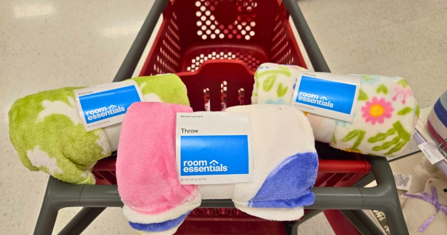 3 Easter themed throw blankets in a Target cart