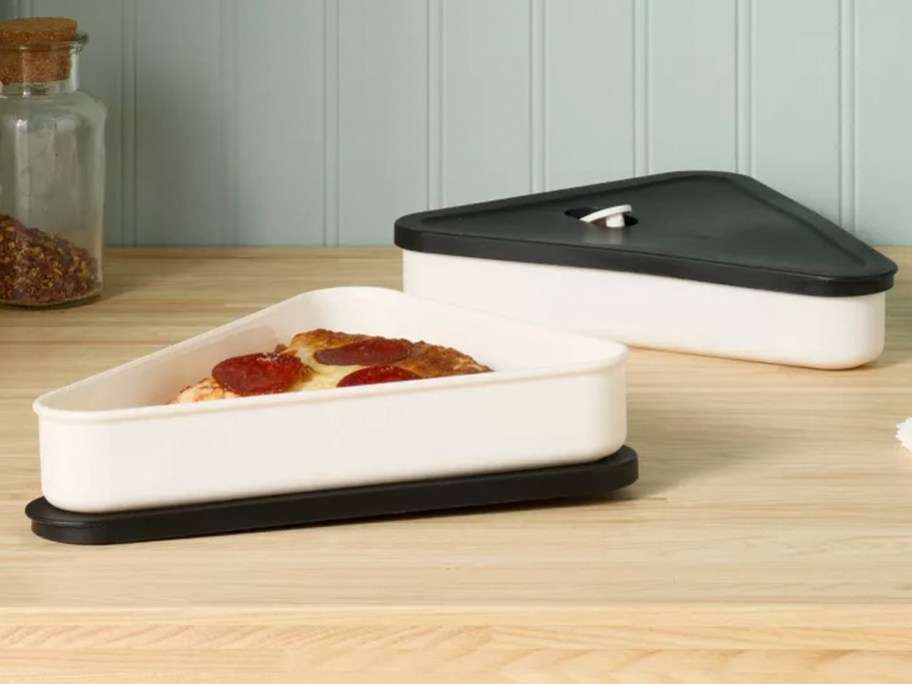 black and white pizza containers on table