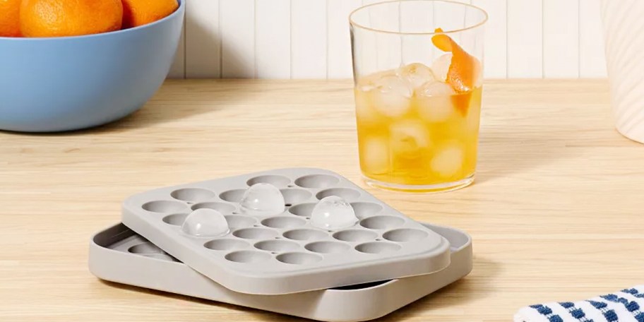 gray sphere ice mold with cup of tea on table