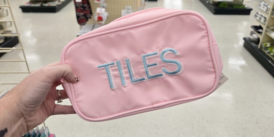 hand holding pink tiles bag