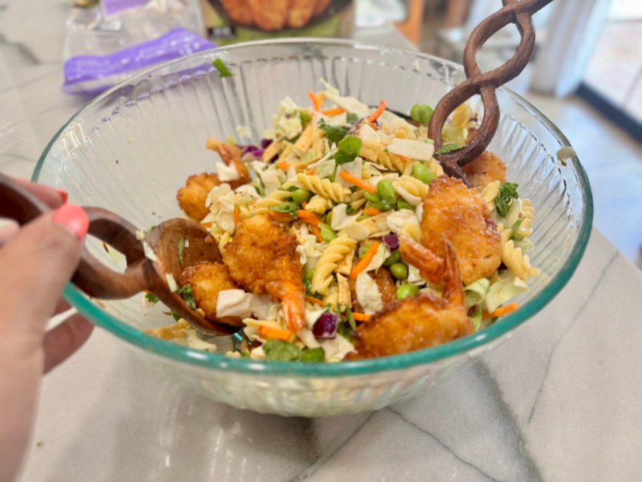 tossing a salad with panko shrimp