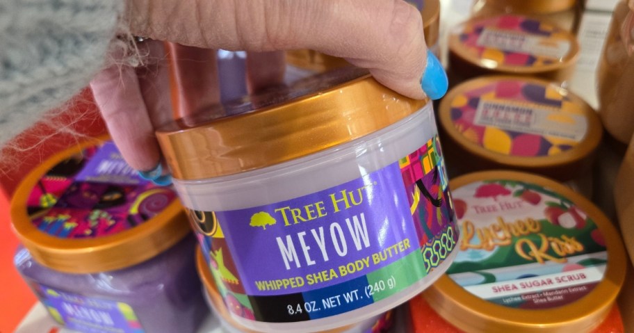 hand holding a jar of Tree Hut Meyow Whipped Body Butter