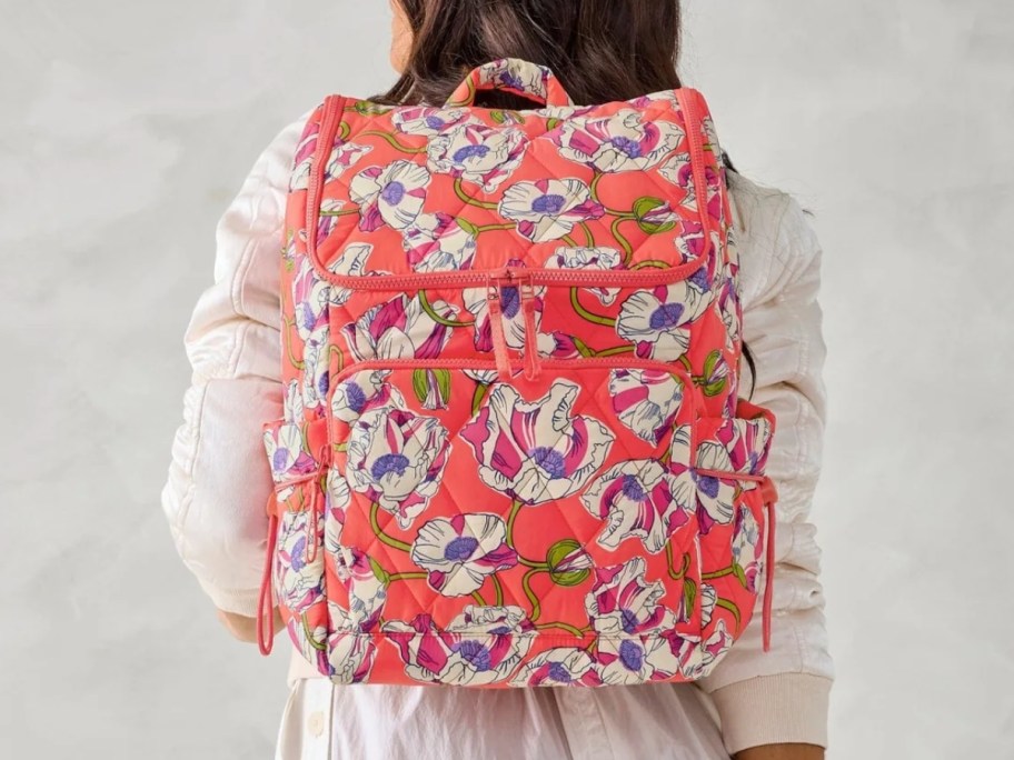 woman with a pink floral backpack on her back