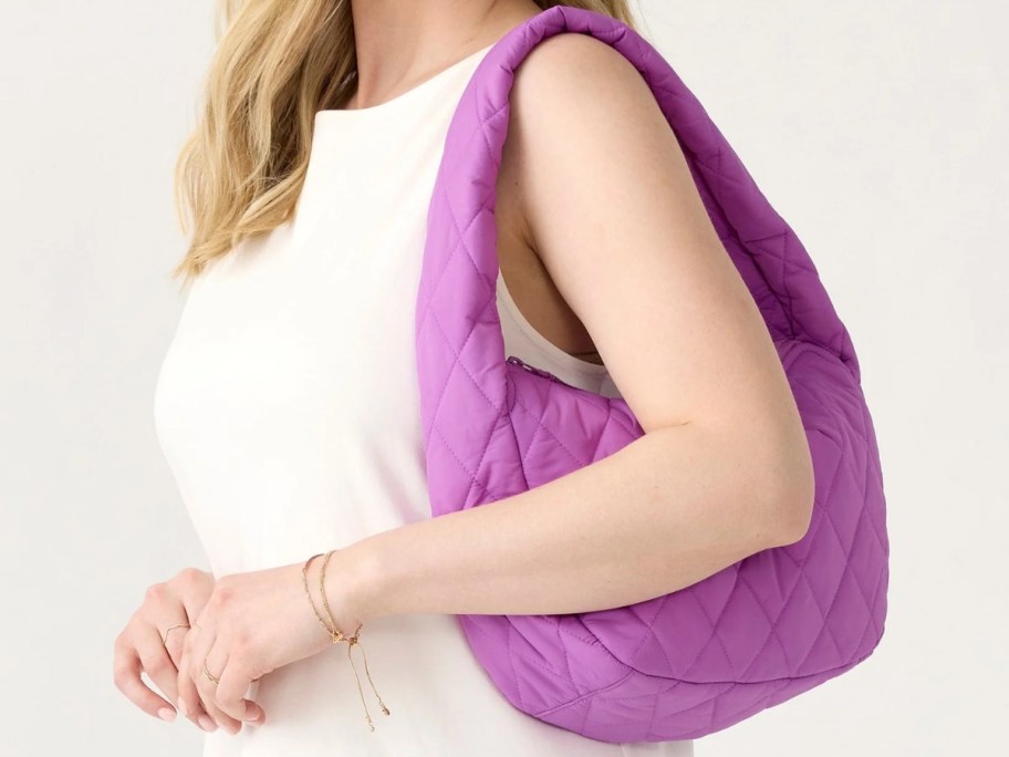 woman with a purple quilted shoulder bag