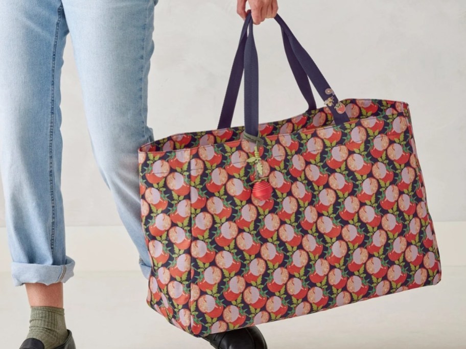 woman carrying a large floral tote bag