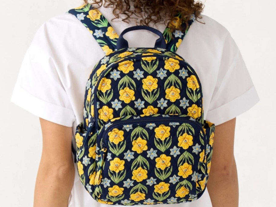 woman wearing a floral small backpack on her back