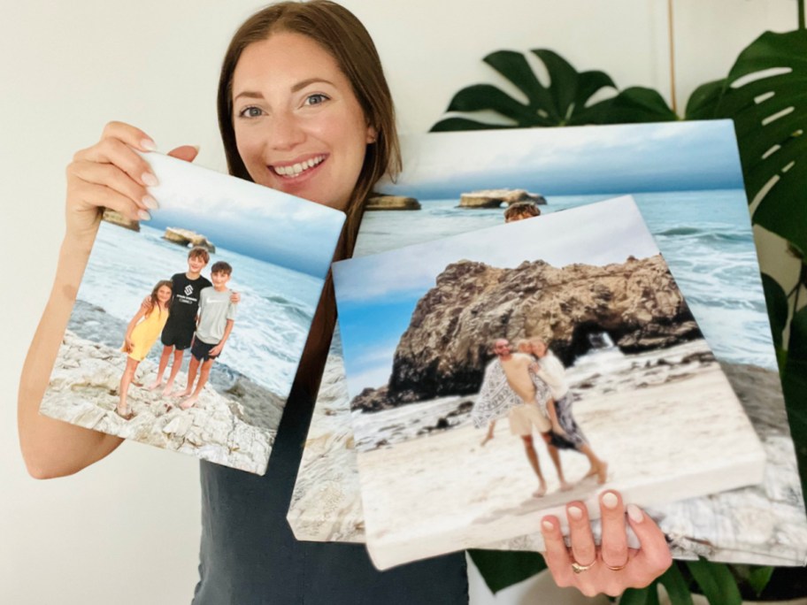 woman holding three canvas prints