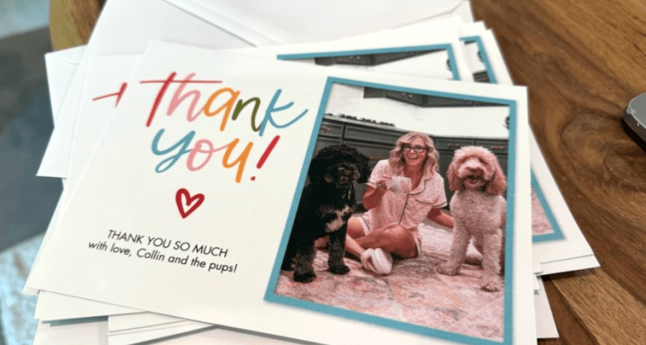 stack of thank you cards on a wood table