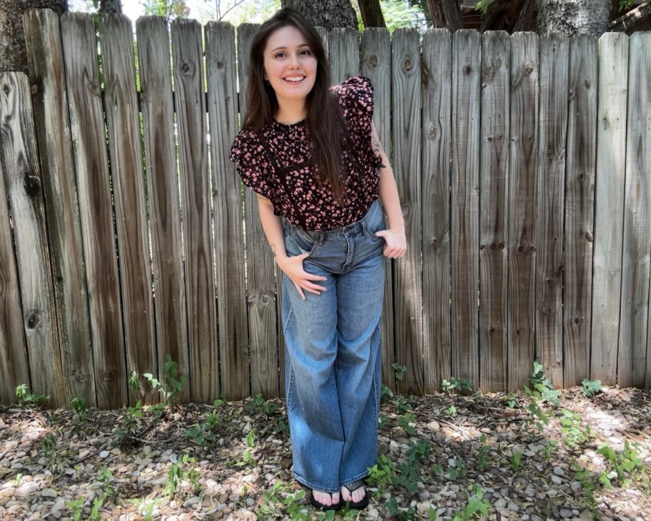 woman in ruffle blouse and wide jeans