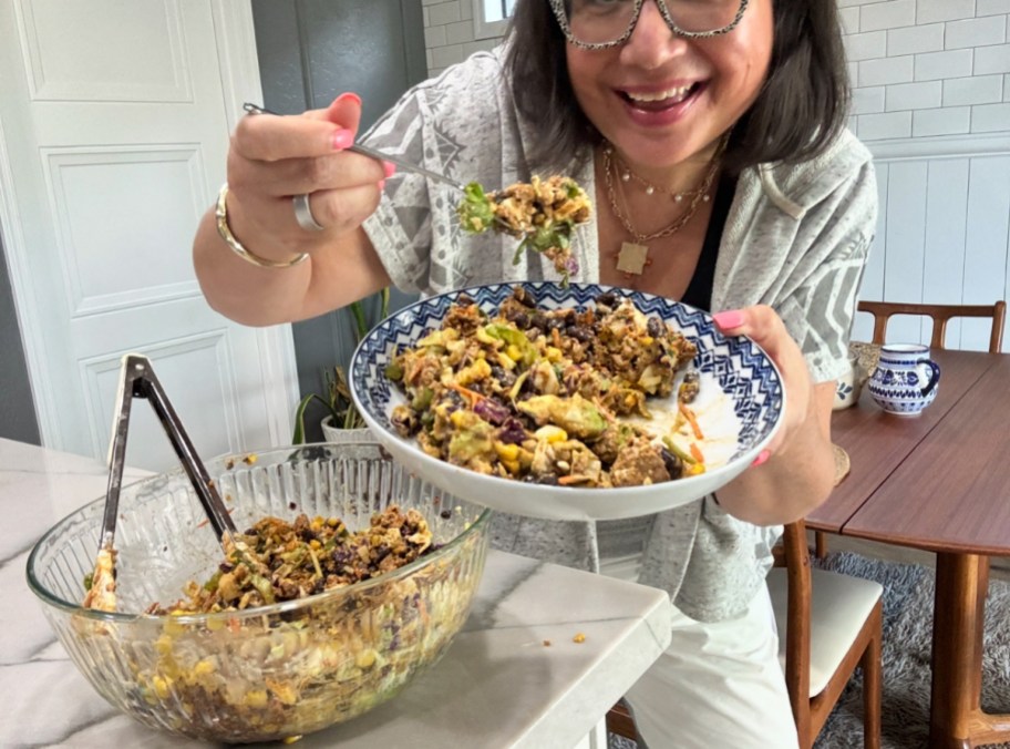 woman eating a salad from a bagged mix