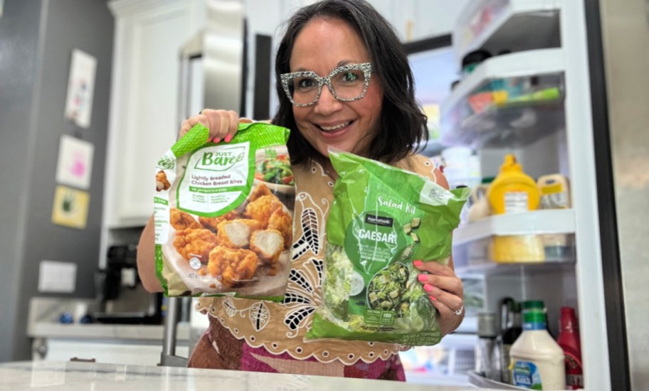 woman holding a bag of salad