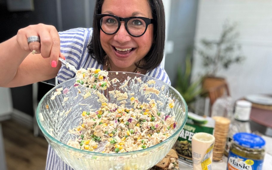 woman holding a bowl of chicken salad 