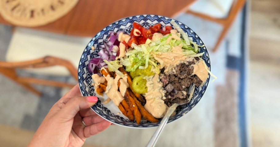 woman holding a burger bowl 