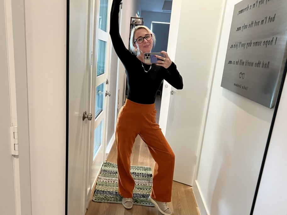 A woman takes a selfie wearing Athleta joggers.
