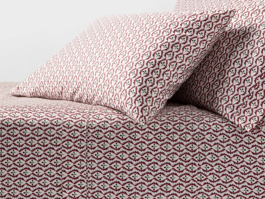 a bed with Christmas sheets on it