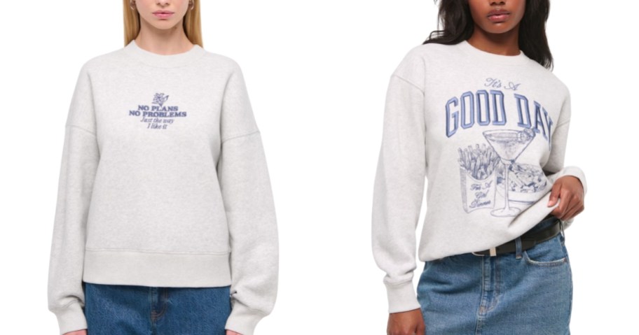 2 women wearing different graphic sweatshirts