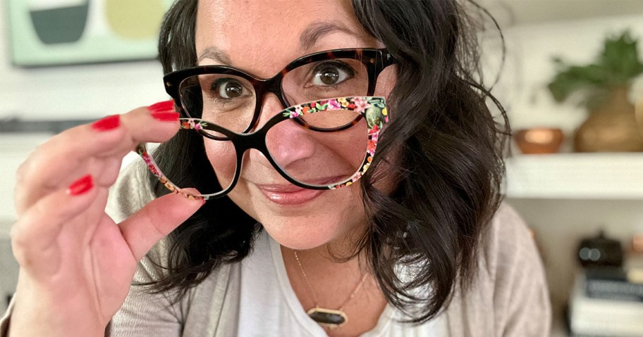 A woman putting on a top frame to her pair eyeglasses