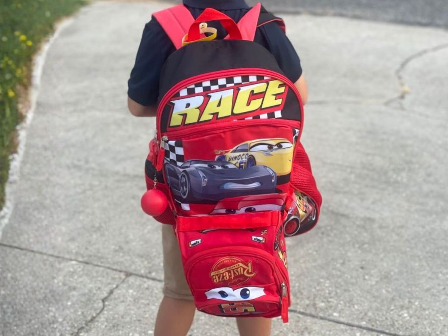 kid wearing Accessory Innovations 4-Piece 16" Disney Cars Backpack Schoolbag w/ Lunch Box & Water Bottle