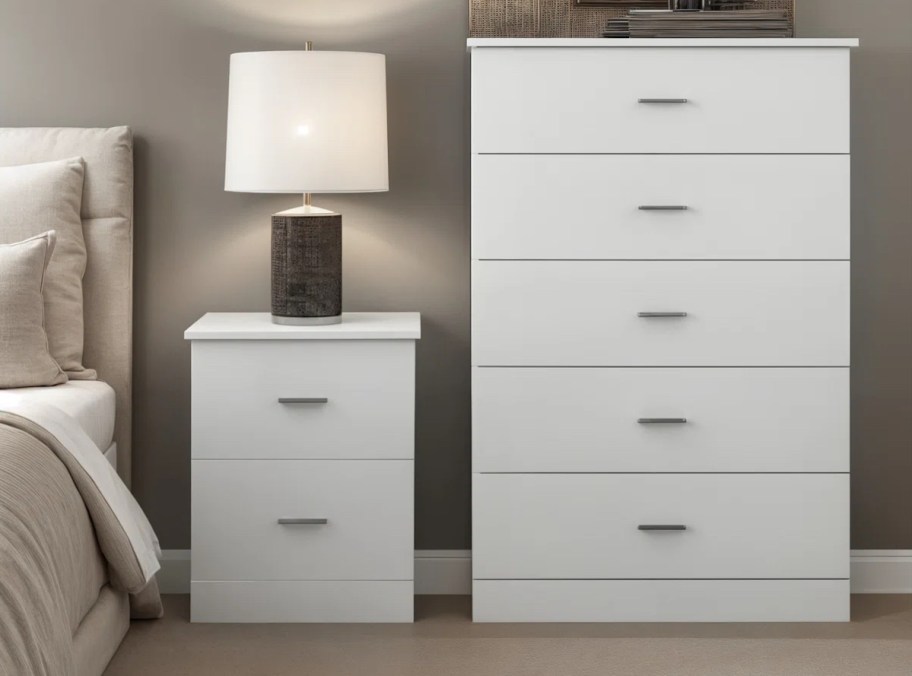 white tall dresser and matching night stand with lamp