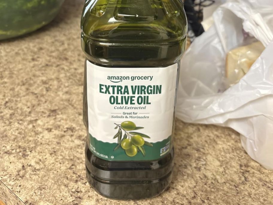 Amazon Grocery Extra Virgin Olive Oil 51oz bottle on counter
