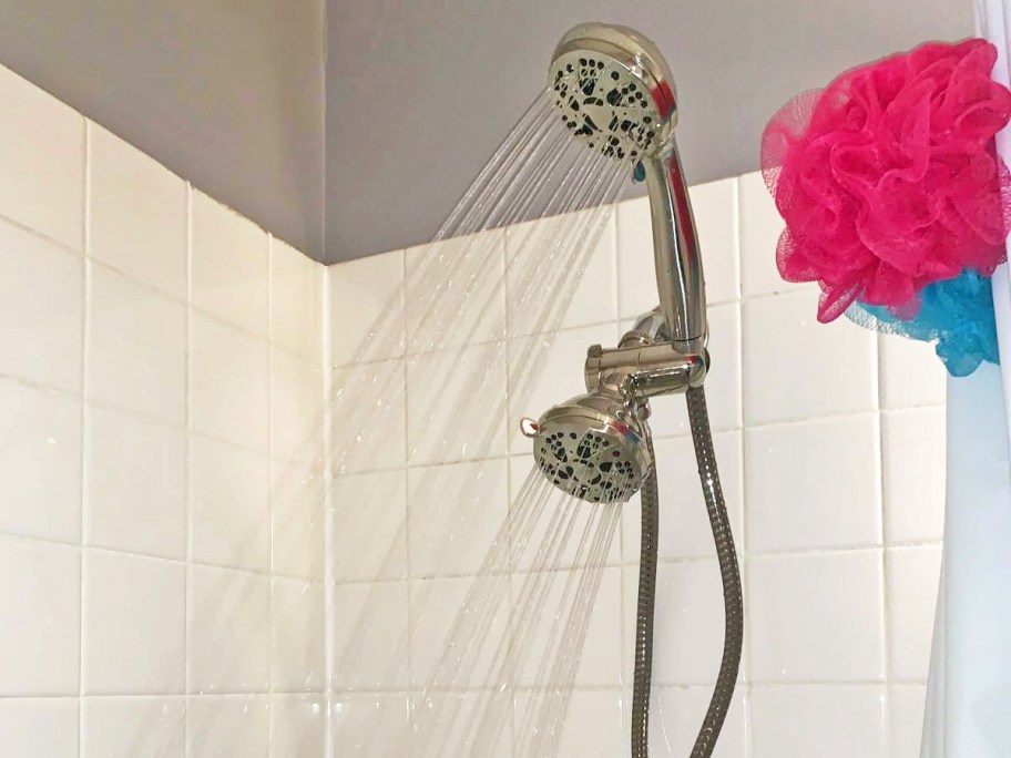 dual shower head in bathroom with both heads spraying at the same time