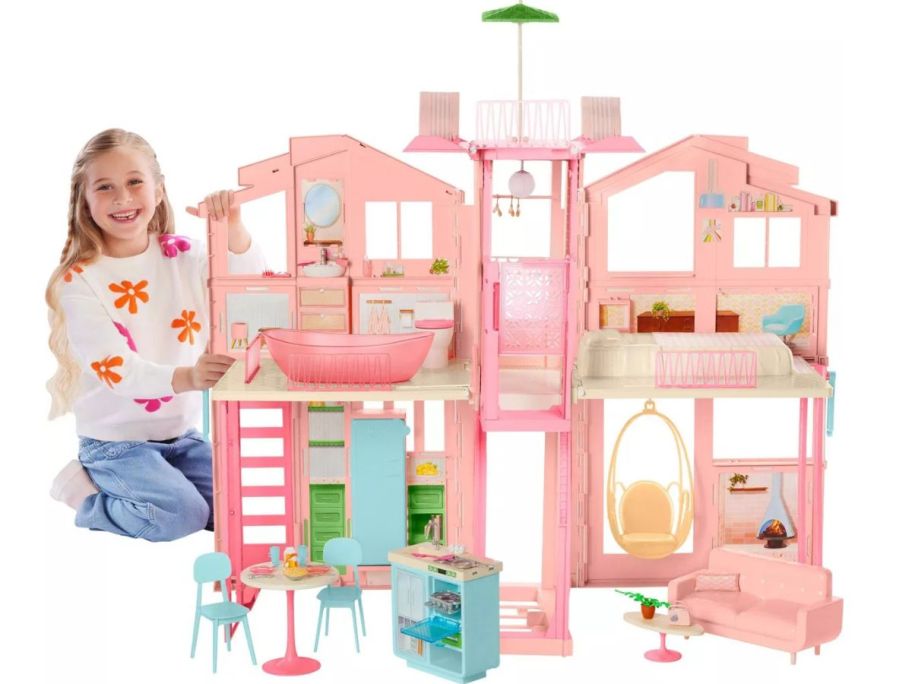 Stock image of a little girl playing with a Barbie Hearth & Hand Magnolia Playset