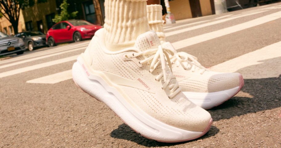 woman wearing a pair of white brooks running shoes