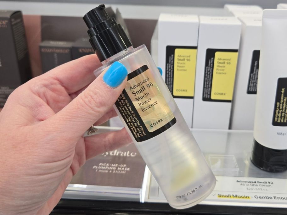 Hand holding a COSRX Advanced Snail 96 Mucin Power Essence