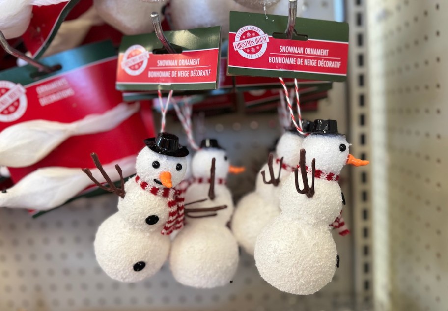 snowman ornaments hanging on store shelf