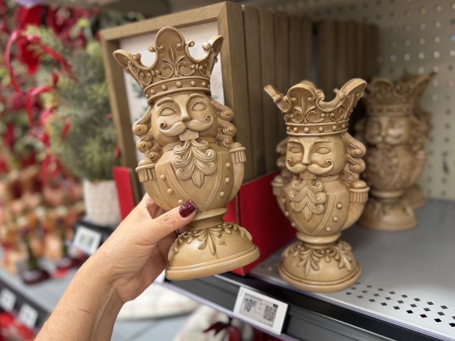 hand holding large Christmas nutcracker candleholder