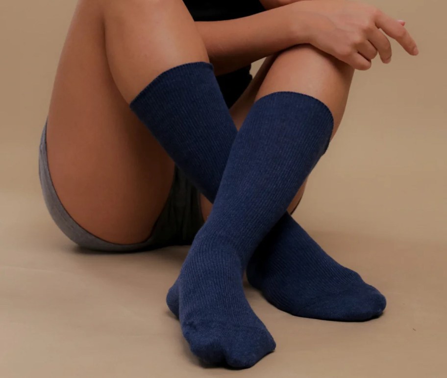 close up of woman wearing navy blue socks