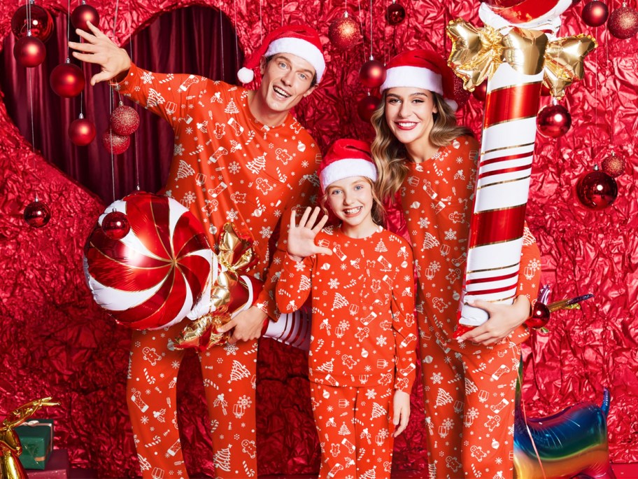 family wearing matching red christmas pajamas