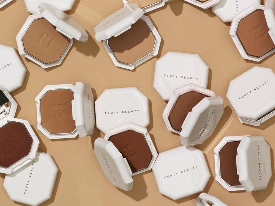 Many compacts of different shades of Fenty Beauty Powder Foundation