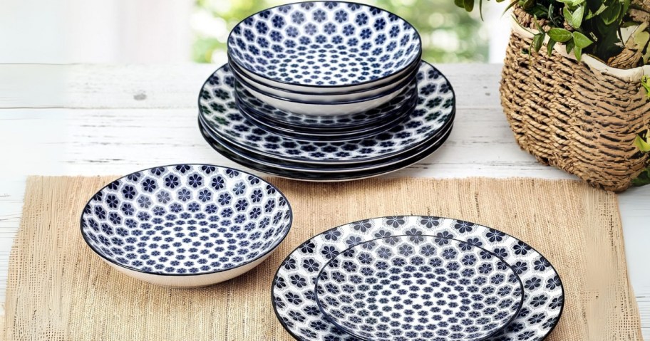 a set of plates and bowls in a blue floral print
