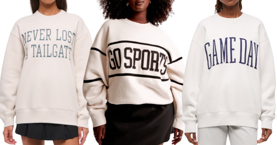3 women wearing sports themed sweatshirts