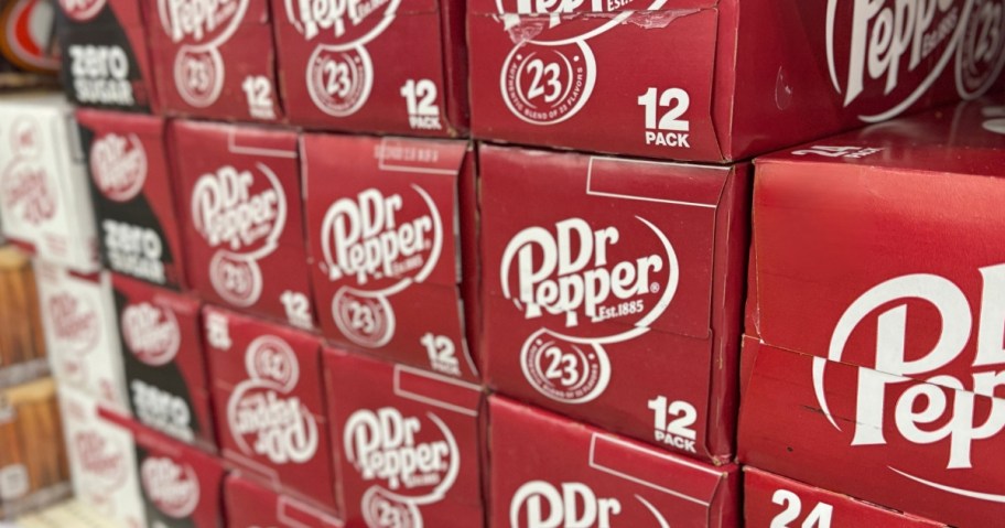 stacks of Dr. Pepper cans packs on a store shelf