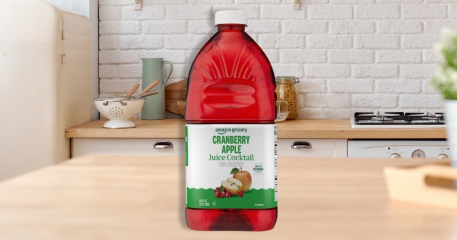 a bottle of amazon grocery cranberry apple juice on a counter