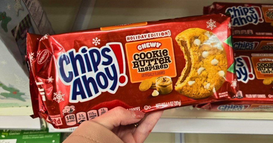 hand holding a pack of CHIPS AHOY! Chewy Cookie Butter-Inspired Cookies, more behind it on a store shelf