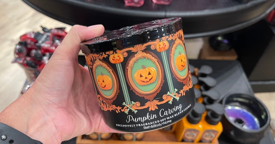 hand holding a Bath & Body Works halloween candle