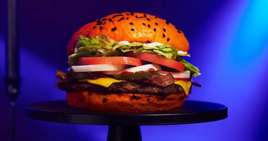 a Jack-o-lantern whopper burger on a black pedestal