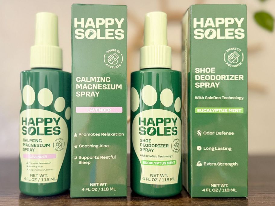 Bottles of Happy Soles Magnesium Foot Spray and Shoe Deodorizer Spray next to the boxes they come in