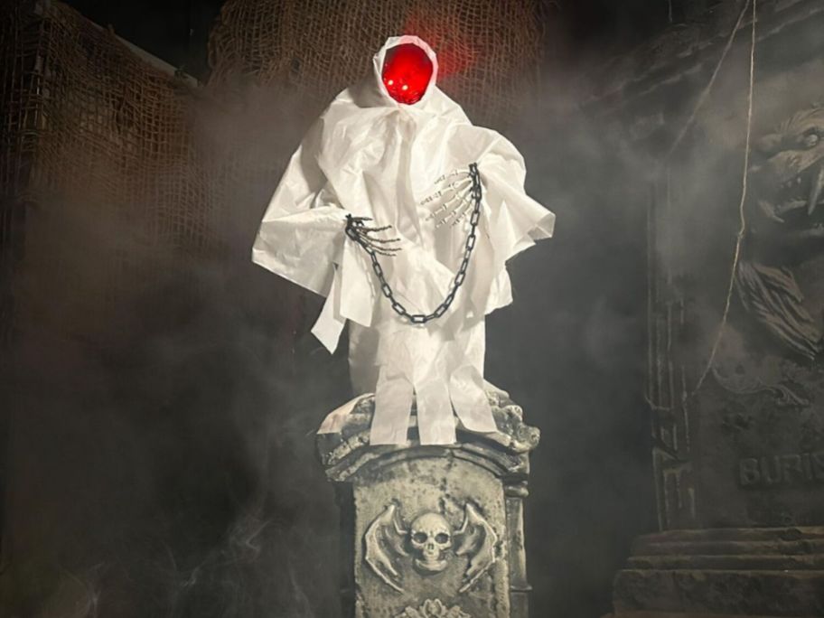 White robed figure on a tomb