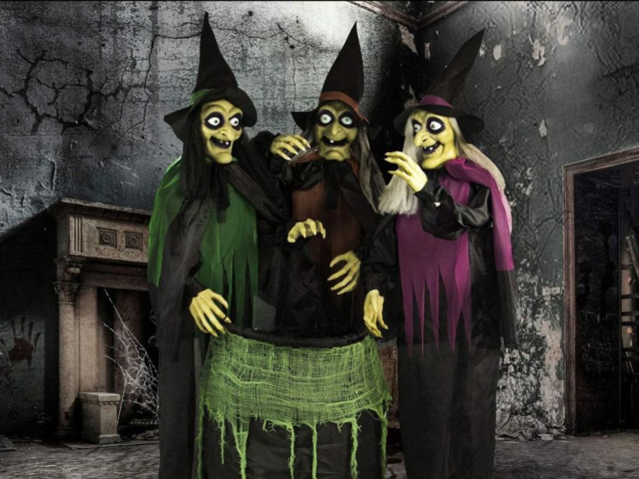 three witches stood around a cauldron