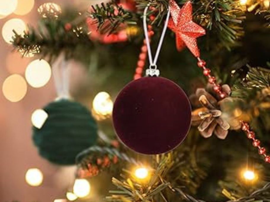 A Christmas tree with flocked ornaments in red and green