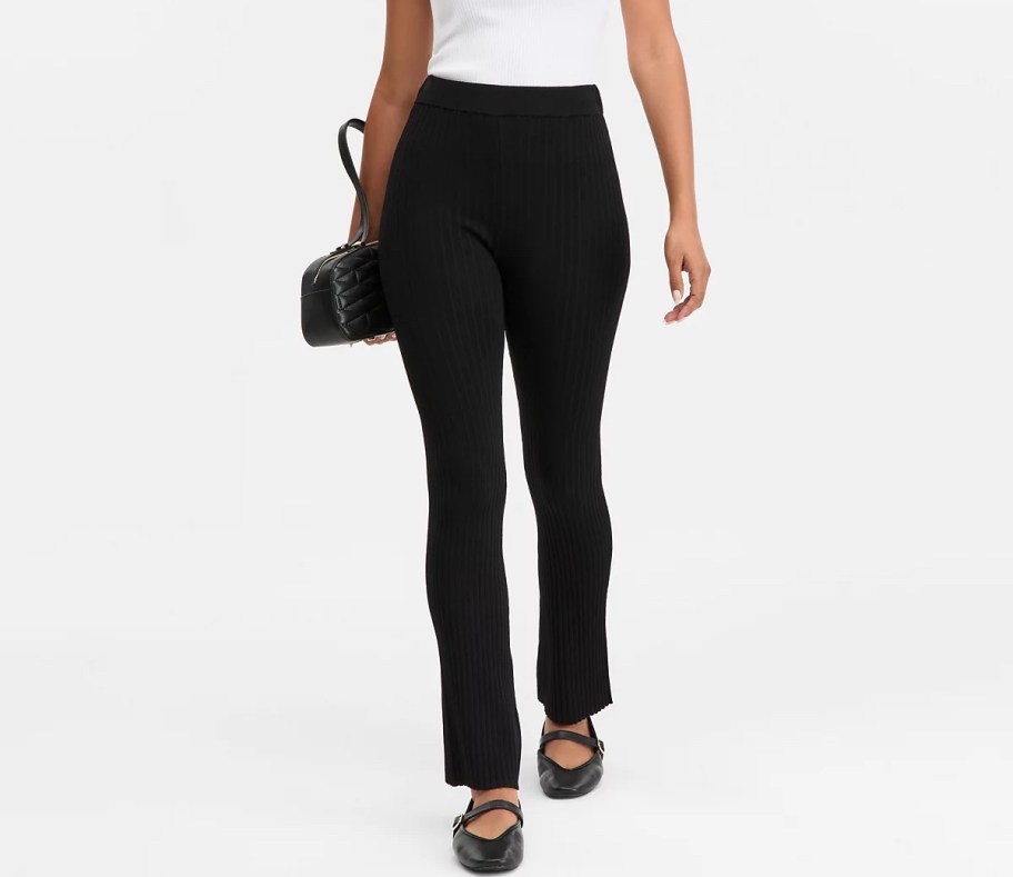 stock photo of women wearing black ribbed pants